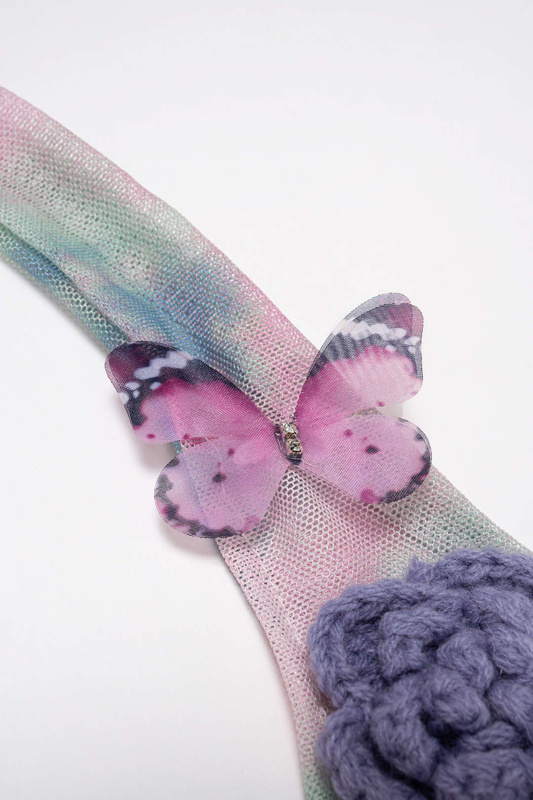 Butterfly-themed headband with pink butterfly and purple flower on a white background